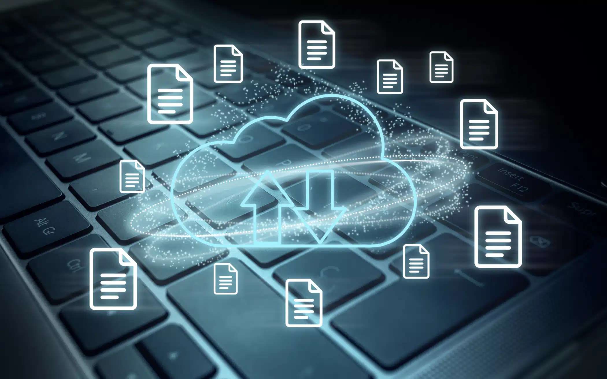 Glowing cloud storage icon with documents above laptop keyboard