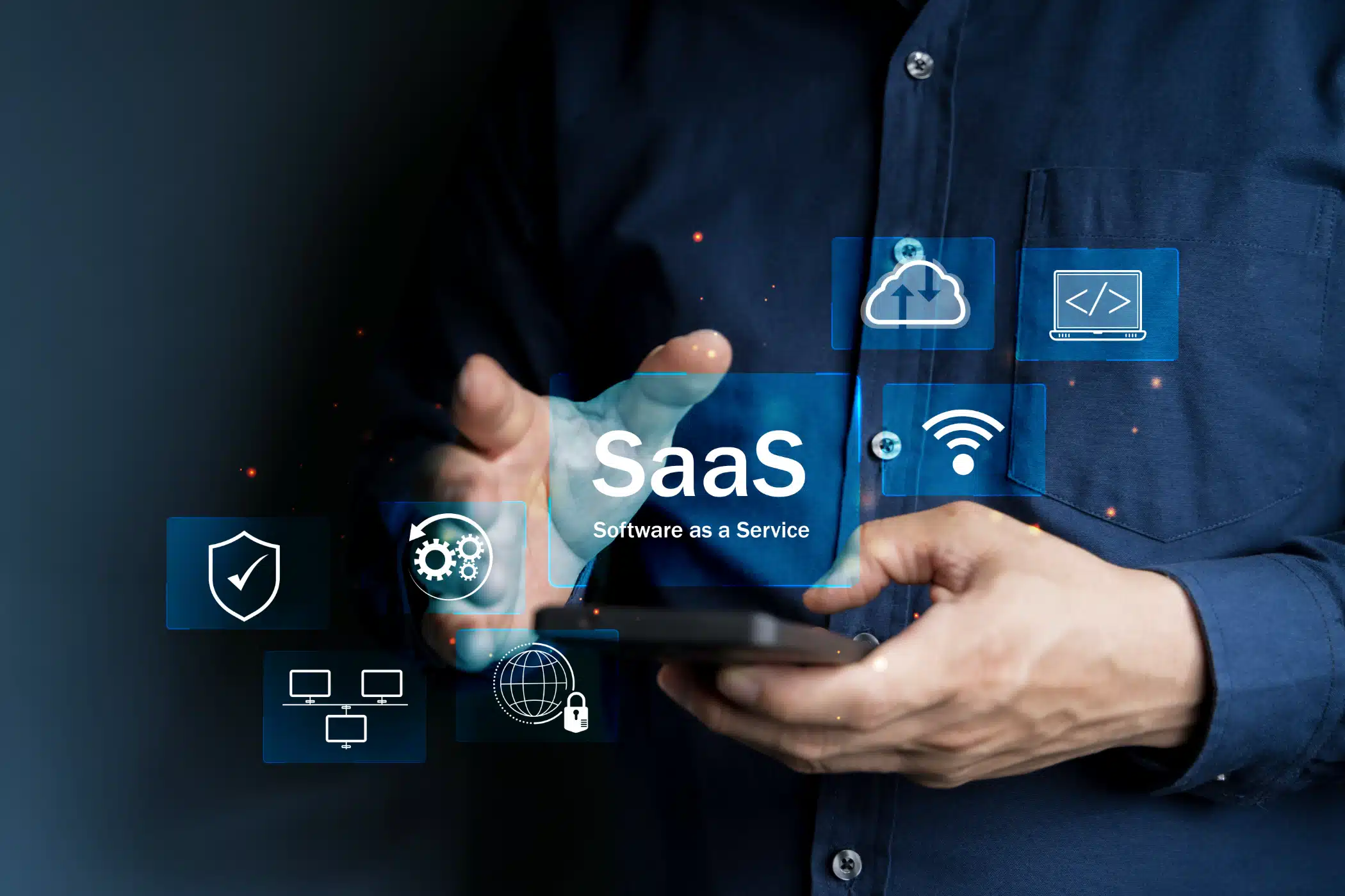 Man holding smartphone with SaaS technology icons floating around